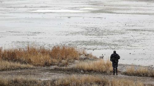 A man looks out over the shoreline at Great Salt Lake State Park in Salt Lake County on Feb. 7. The lake's southern arm is already back to its 2023 peak and could reach 4,195 feet elevation this year for the first time since 2019, experts say. (Kristin Murphy, Deseret News).